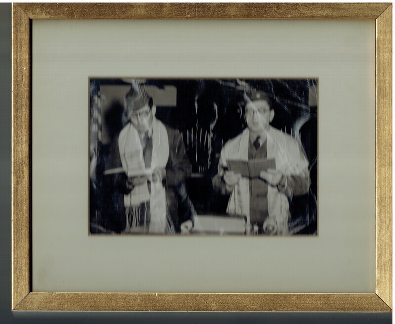 Photo of two men wearing a tallis and leading prayers; men are dressed in army uniforms